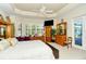 Spacious main bedroom with king-size bed, access to patio, and ample closet space at 5118 Chateau Ct, Sarasota, FL 34238