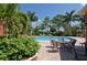 Inviting pool area with lounge chairs and patio furniture at 5118 Chateau Ct, Sarasota, FL 34238