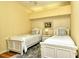 Bedroom with two twin beds and ceiling fan at 5250 Hyland Hills Ave # 1525, Sarasota, FL 34241