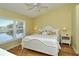 Main bedroom with water views and a ceiling fan at 5250 Hyland Hills Ave # 1525, Sarasota, FL 34241