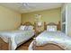 Guest bedroom with two twin beds and ceiling fan at 5250 Hyland Hills Ave # 1525, Sarasota, FL 34241