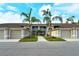 Condo building exterior with palm trees and garages at 5250 Hyland Hills Ave # 1525, Sarasota, FL 34241