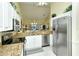 Bright kitchen featuring granite countertops and stainless steel appliances at 5250 Hyland Hills Ave # 1525, Sarasota, FL 34241