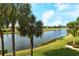 Beautiful lake view with palm trees from a condo balcony at 5250 Hyland Hills Ave # 1525, Sarasota, FL 34241