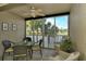 Screened balcony with lake view and seating area at 5250 Hyland Hills Ave # 1525, Sarasota, FL 34241