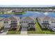 Three two-story houses next to each other near a lake at 5307 Grove Mill Loop, Lakewood Ranch, FL 34211