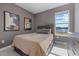 Cozy bedroom with lake view and neutral color palette at 5307 Grove Mill Loop, Lakewood Ranch, FL 34211