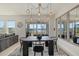 Modern dining area features a dark wood table with black chairs at 5307 Grove Mill Loop, Lakewood Ranch, FL 34211