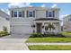 Two-story house with gray siding, gray shutters, and a two-car garage at 5307 Grove Mill Loop, Lakewood Ranch, FL 34211