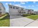 Two story house with gray siding, two-car garage, and landscaped yard at 5307 Grove Mill Loop, Lakewood Ranch, FL 34211