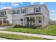 Two-story house with gray siding, gray shutters, landscaping, and a two-car garage at 5307 Grove Mill Loop, Lakewood Ranch, FL 34211