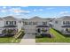 Two-story house with gray siding, two-car garage, and landscaped yard at 5307 Grove Mill Loop, Lakewood Ranch, FL 34211