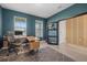 Home office with teal walls, a desk, and view of the entryway at 5307 Grove Mill Loop, Lakewood Ranch, FL 34211