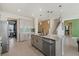 Modern kitchen with granite countertops and an island with sink at 5307 Grove Mill Loop, Lakewood Ranch, FL 34211