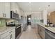 Modern kitchen with stainless steel appliances and large island at 5307 Grove Mill Loop, Lakewood Ranch, FL 34211