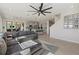 Open living room showcasing a sectional sofa and kitchen view at 5307 Grove Mill Loop, Lakewood Ranch, FL 34211