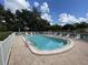 Community pool with lounge chairs and a surrounding fence at 5449 Chanteclaire # 75, Sarasota, FL 34235