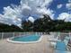 Community pool with plenty of lounge chairs at 5449 Chanteclaire # 75, Sarasota, FL 34235