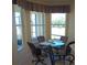 Breakfast nook with a glass-top table and view of the backyard at 5452 Club View Ln, North Port, FL 34287