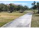 Landscaped walkway alongside a lush green golf course at 5452 Club View Ln, North Port, FL 34287