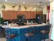 Well-equipped kitchen with wood cabinets and a breakfast bar at 5452 Club View Ln, North Port, FL 34287