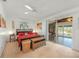 Bedroom with king bed and access to sunroom and bathroom at 550 De Narvaez Dr, Longboat Key, FL 34228