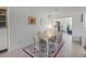 Light-filled dining area with a wood table and six chairs at 550 De Narvaez Dr, Longboat Key, FL 34228