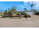 Front view of the house with a landscaped yard and driveway at 550 De Narvaez Dr, Longboat Key, FL 34228