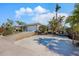 House exterior with driveway and tropical landscaping at 550 De Narvaez Dr, Longboat Key, FL 34228