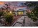 Home exterior with stone pathway and tropical landscaping at 550 De Narvaez Dr, Longboat Key, FL 34228