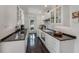 Clean kitchen featuring white cabinets and dark countertops at 550 De Narvaez Dr, Longboat Key, FL 34228