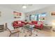 Living room featuring red sofas, a coffee table, and large windows at 550 De Narvaez Dr, Longboat Key, FL 34228