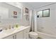 Well-lit bathroom featuring a double sink vanity, shower-tub combo, and neutral color palette at 5616 Mashie Cir, North Port, FL 34287