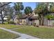 Exterior view of the home showcasing the landscape, walkways, and curb appeal at 5616 Mashie Cir, North Port, FL 34287