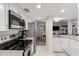 Modern kitchen featuring white cabinetry, stainless steel appliances, and ample counter space, ideal for cooking at 5616 Mashie Cir, North Port, FL 34287