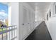 Clean condo hallway with white doors and railing at 5907 Todd St # E36, Bradenton, FL 34207