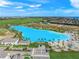 Aerial view of a crystal lagoon community with homes and landscaping at 6039 Salt Grass St, Bradenton, FL 34210