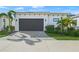 Attached garage with dark brown door and paver driveway at 6039 Salt Grass St, Bradenton, FL 34210