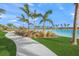 Concrete walkway winds through lush landscaping toward lagoon at 6039 Salt Grass St, Bradenton, FL 34210