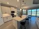 Modern kitchen with white cabinets, center island, and stainless steel appliances at 649 Maraviya Blvd, Nokomis, FL 34275