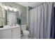 Clean bathroom with white vanity, shower, and marble-look floor at 6507 36Th Avenue W Dr, Bradenton, FL 34209