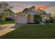 Inviting yellow house with a white garage door and landscaped lawn at 6507 36Th Avenue W Dr, Bradenton, FL 34209