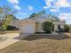 Bright yellow house with a white garage door and well-maintained lawn at 6507 36Th Avenue W Dr, Bradenton, FL 34209