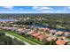 Aerial view of community with homes and lake at 6841 74Th Street E Cir, Bradenton, FL 34203