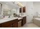 Spacious bathroom with double sinks, a soaking tub, and a separate shower at 6841 74Th Street E Cir, Bradenton, FL 34203