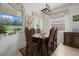 Elegant dining room with a large table and garden views at 6841 74Th Street E Cir, Bradenton, FL 34203