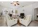 Open living room with white leather furniture and access to other rooms at 6841 74Th Street E Cir, Bradenton, FL 34203