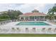 Community pool with clubhouse and lounge chairs at 6841 74Th Street E Cir, Bradenton, FL 34203