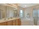 Bathroom with double vanity, soaking tub, and walk-in shower at 6920 74Th Street E Cir, Bradenton, FL 34203