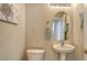 Small bathroom with pedestal sink and toilet at 6920 74Th Street E Cir, Bradenton, FL 34203